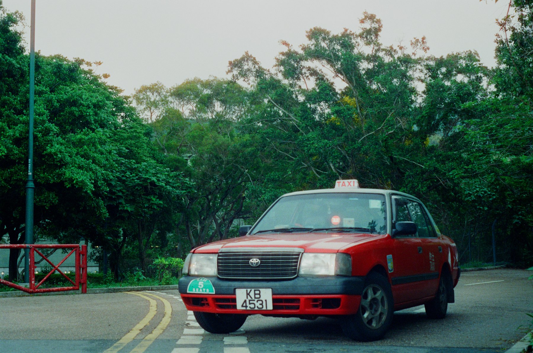 Hong Kong red taxi on coastal highway